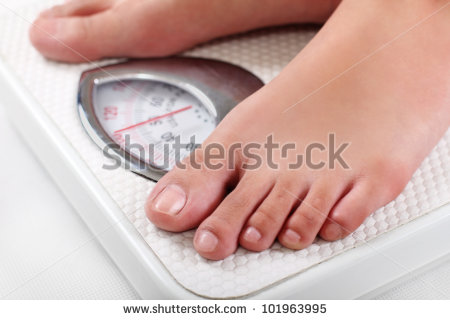 stock-photo-feet-on-a-weighing-scale-close-up-101963995.jpg